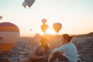 People Sitting on Rooftop During Sunset