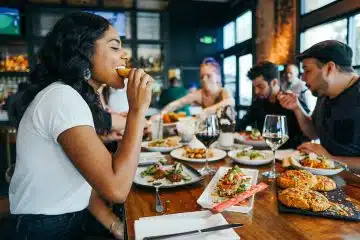 woman in white shirt eating