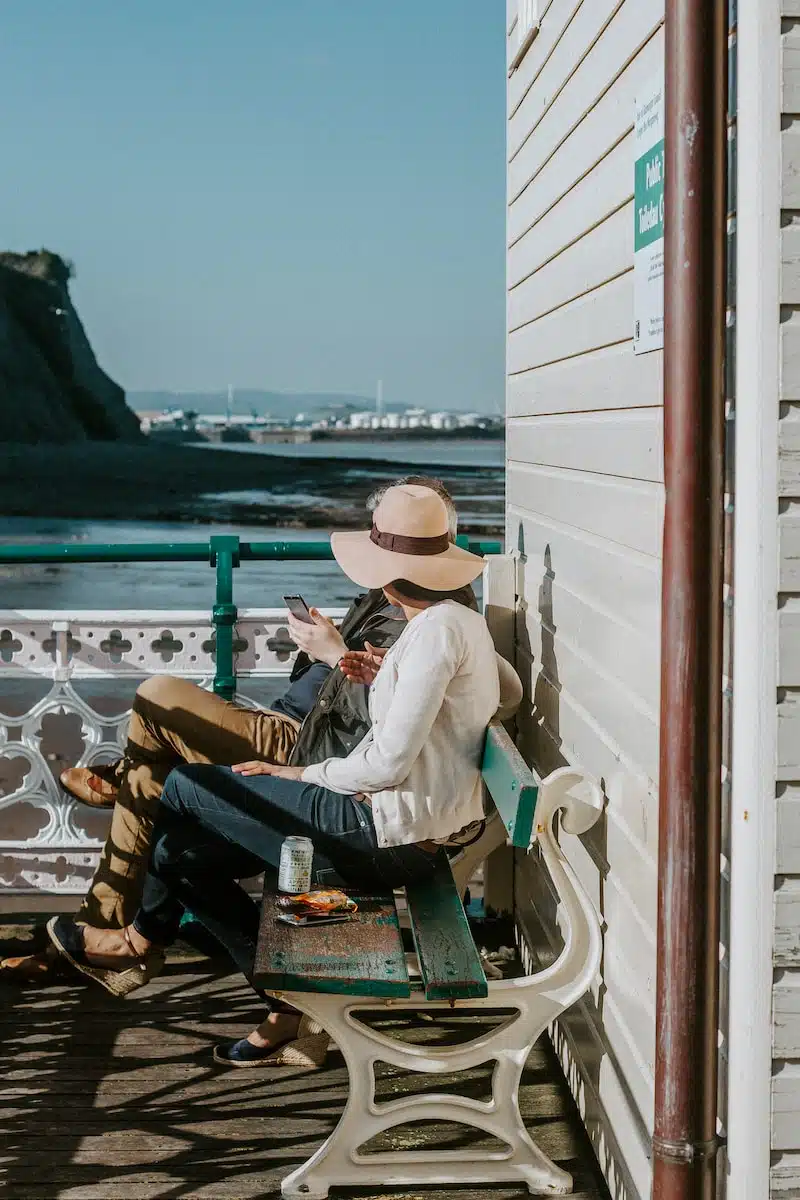 man and woman sitting on bench